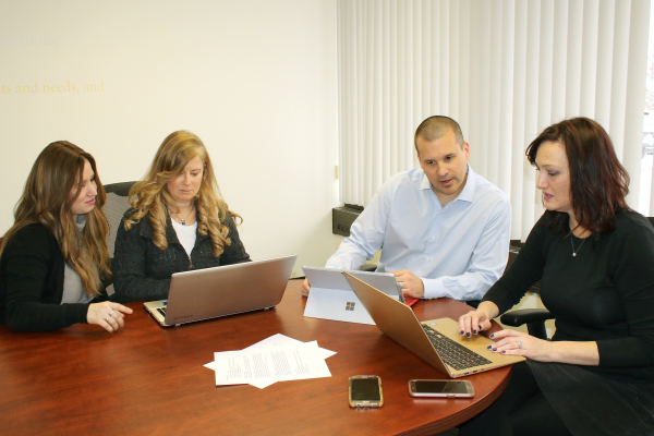 Rosman Team looking at candidate info at a table